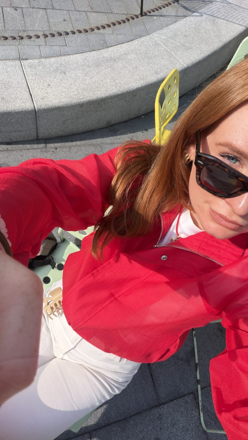 Claudia Bickers in a red jacket and sunglasses